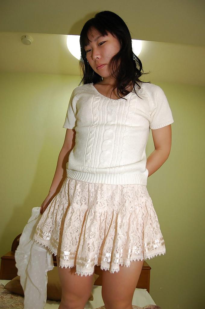 15P Awesome brunette asian teen Noriko is showing her amazing pussy