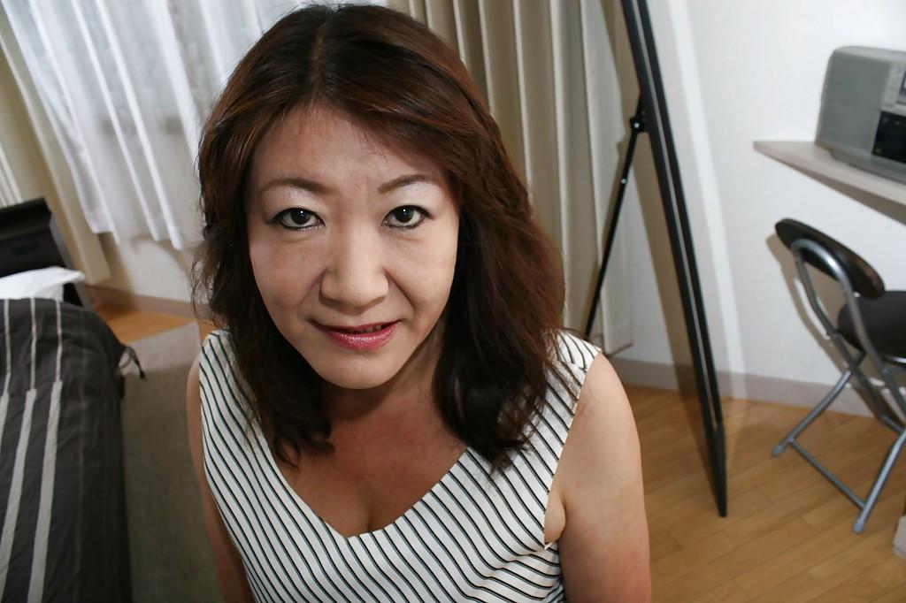 16P Asian granny Michiko Okawa undressing and exposing her hairy twat in close up