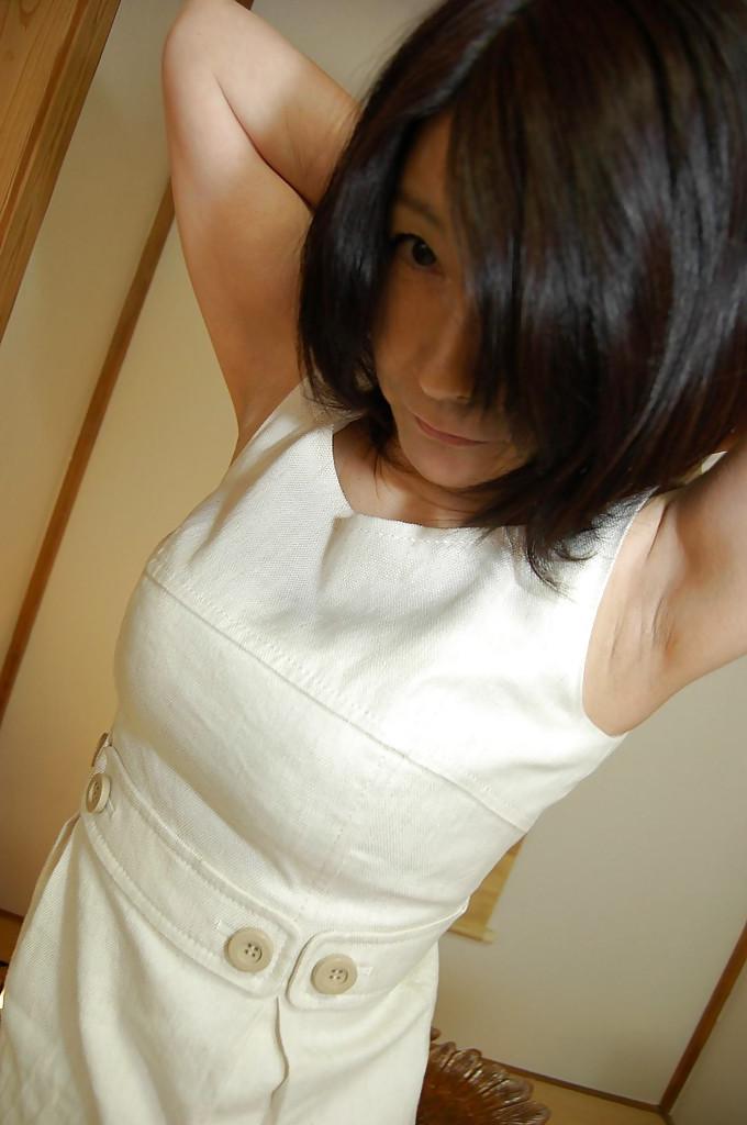 16P Naughty asian mature lassie getting nude and exposing her shaggy gash