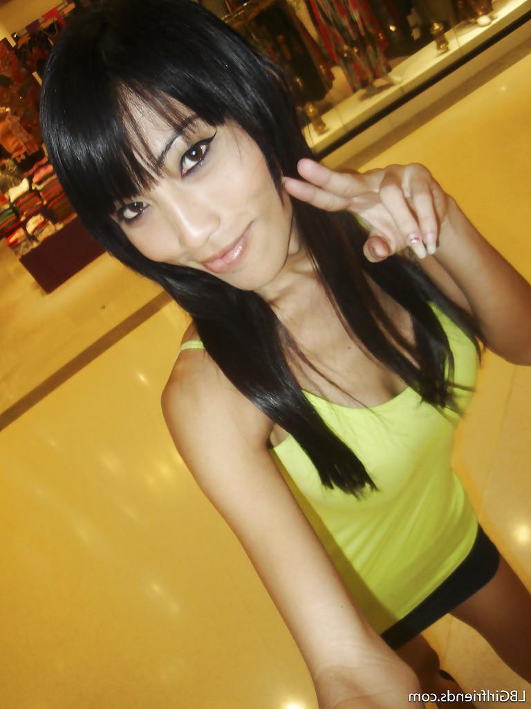16P Big tit Asian tranny Fon posing outdoors and flashing her boobs in public