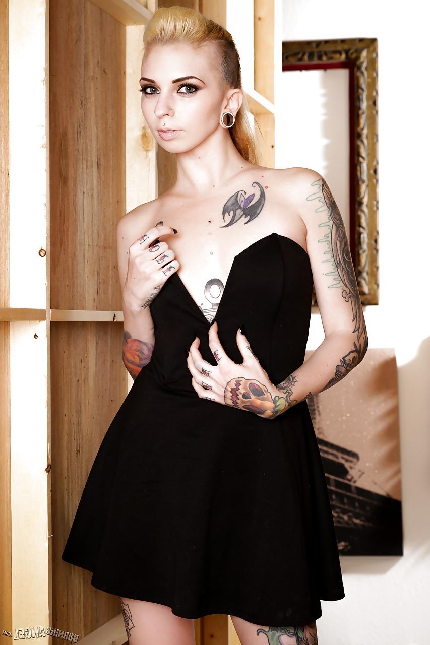 13P Tattooed fetish model Sierra Cure revealing tiny breasts and sexy legs