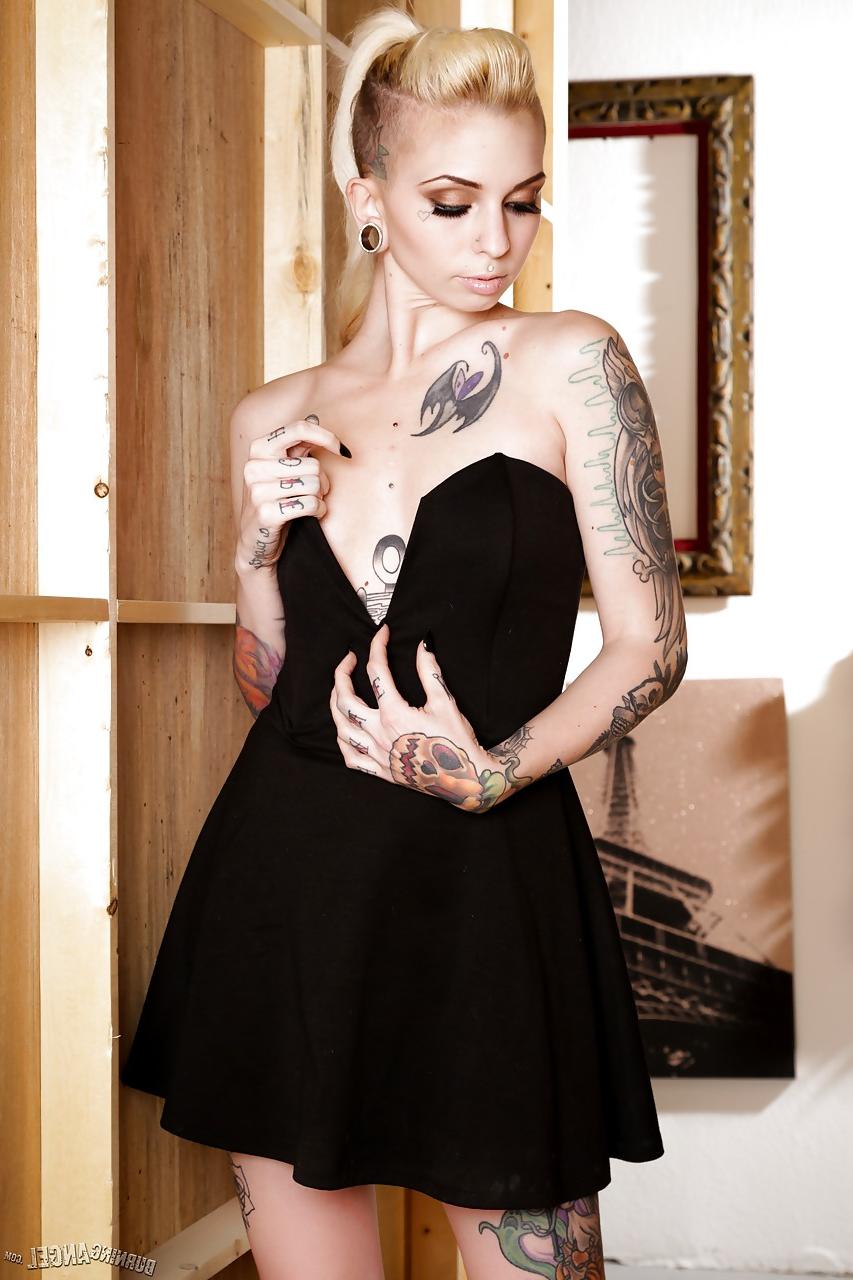 13P Tattooed fetish model Sierra Cure revealing tiny breasts and sexy legs