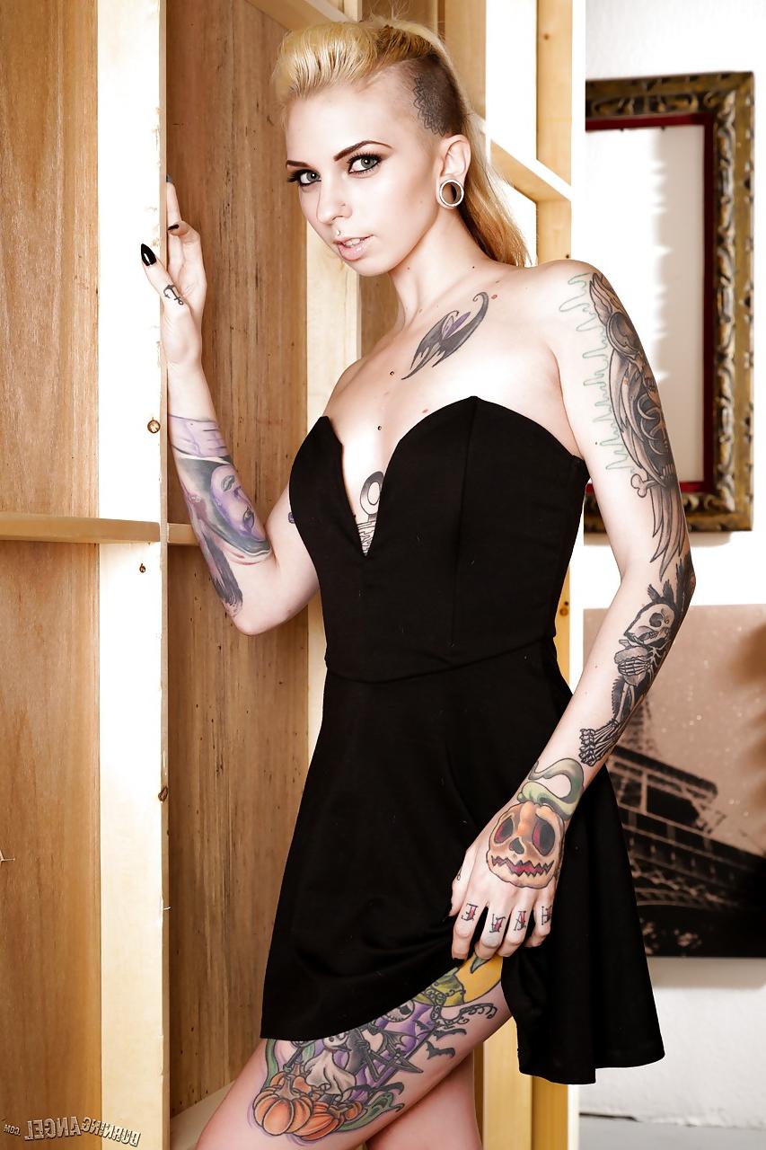 13P Tattooed fetish model Sierra Cure revealing tiny breasts and sexy legs