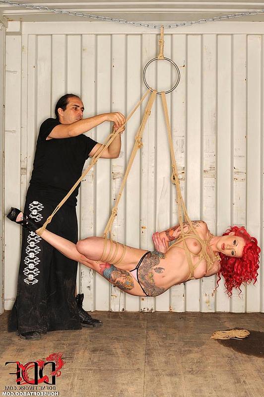 16P Tattooed redhead fetish model Becky Holt suspended by rope for BDSM shoot