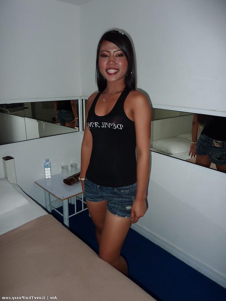 14P Seductive asian babe with slender legs posing in jeans shorts and black top