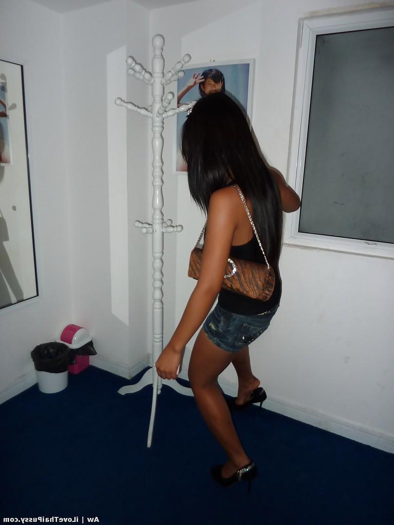 14P Seductive asian babe with slender legs posing in jeans shorts and black top