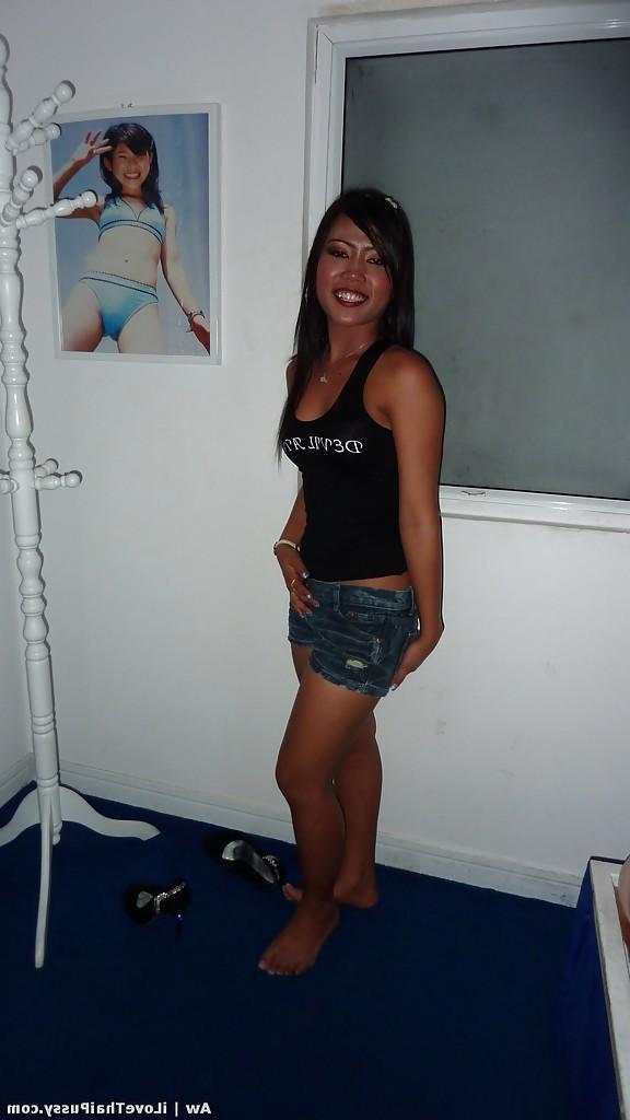 14P Seductive asian babe with slender legs posing in jeans shorts and black top