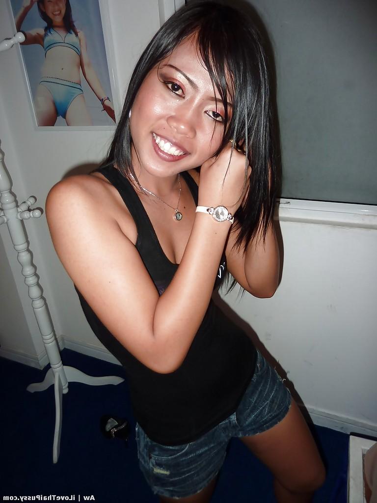 14P Seductive asian babe with slender legs posing in jeans shorts and black top