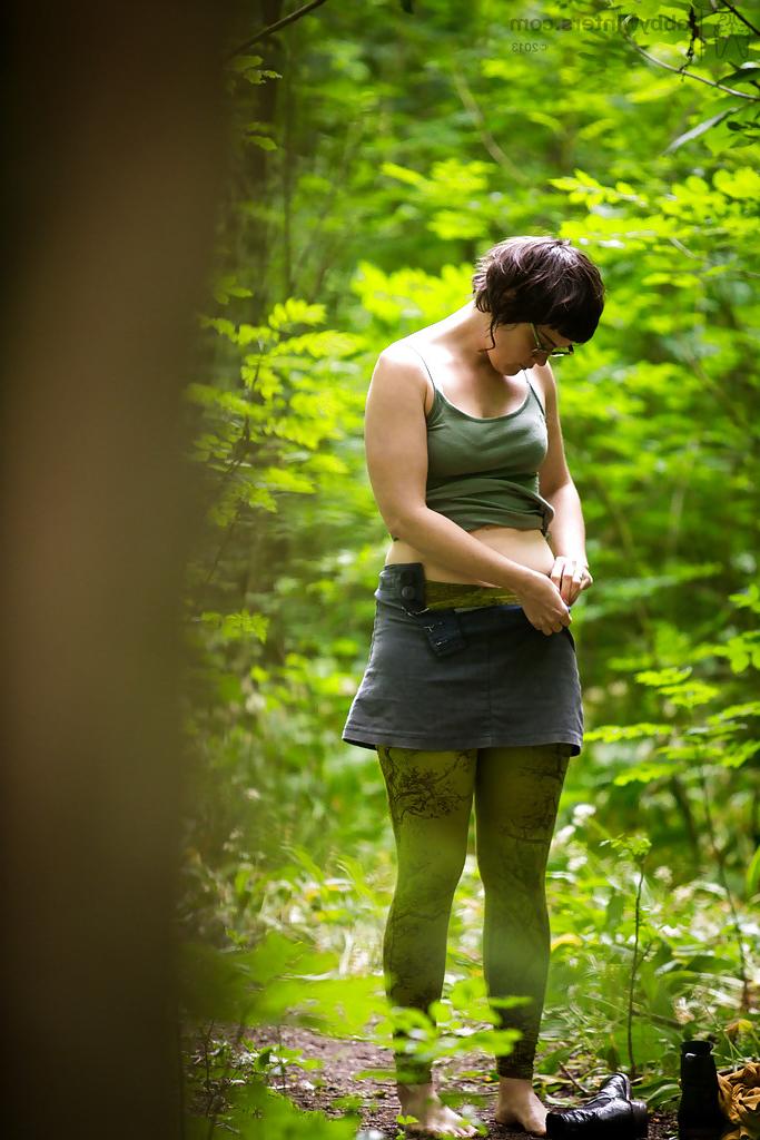 16P Voyeur snaps of naked brunette chick in glasses getting dressed in woods