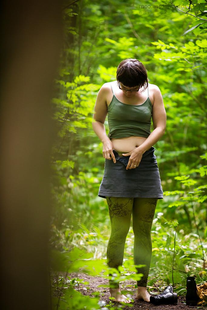 16P Voyeur snaps of naked brunette chick in glasses getting dressed in woods