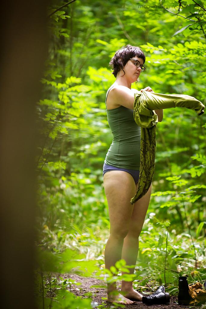 16P Voyeur snaps of naked brunette chick in glasses getting dressed in woods