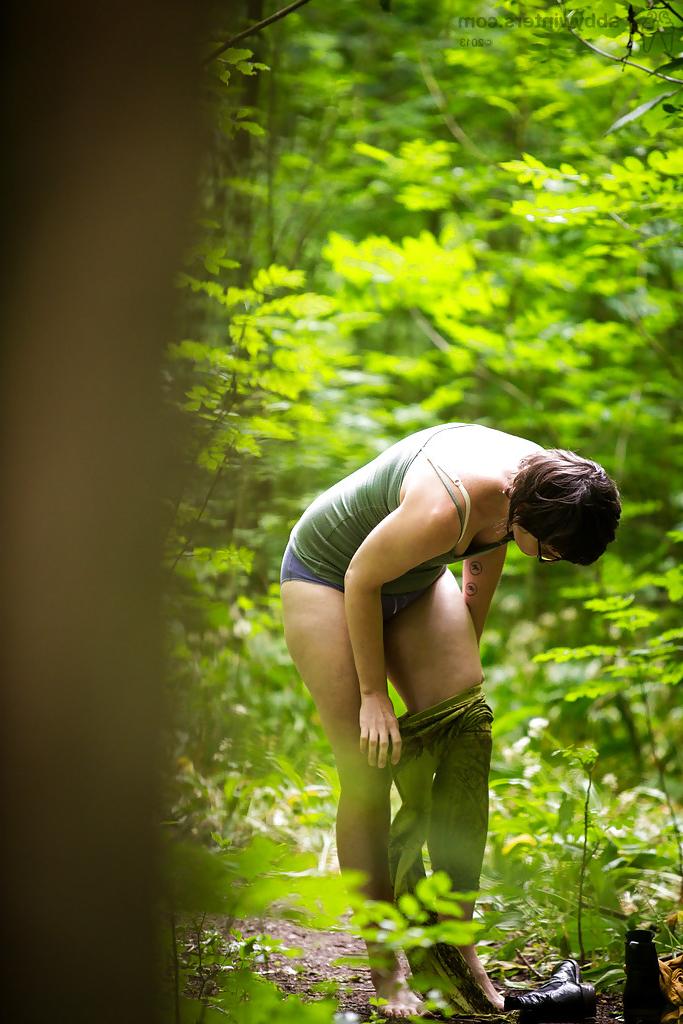 16P Voyeur snaps of naked brunette chick in glasses getting dressed in woods