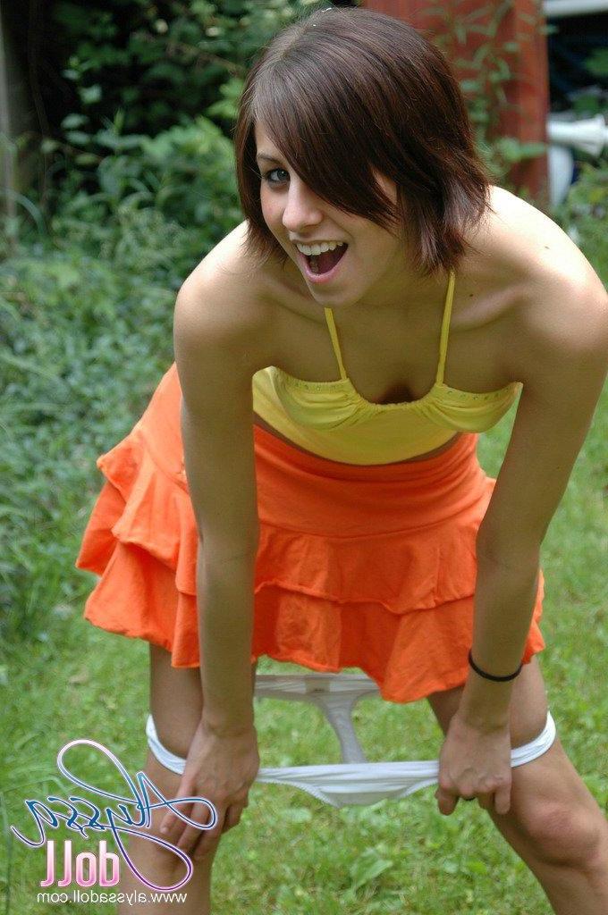 15P Pictures of Alyssa Doll flashing her perky tits outside
