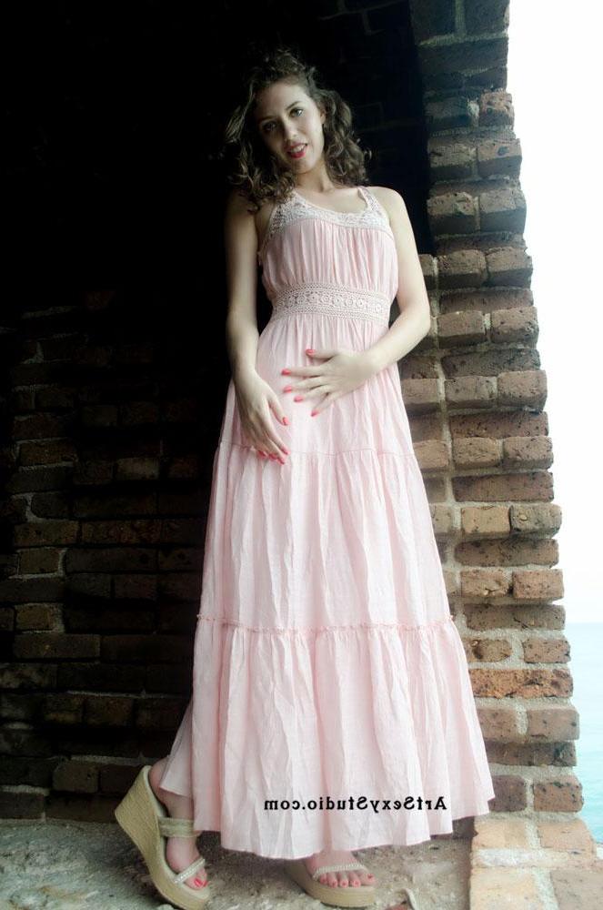 16P Brunette model Blush strips and teases in a brick wall basement