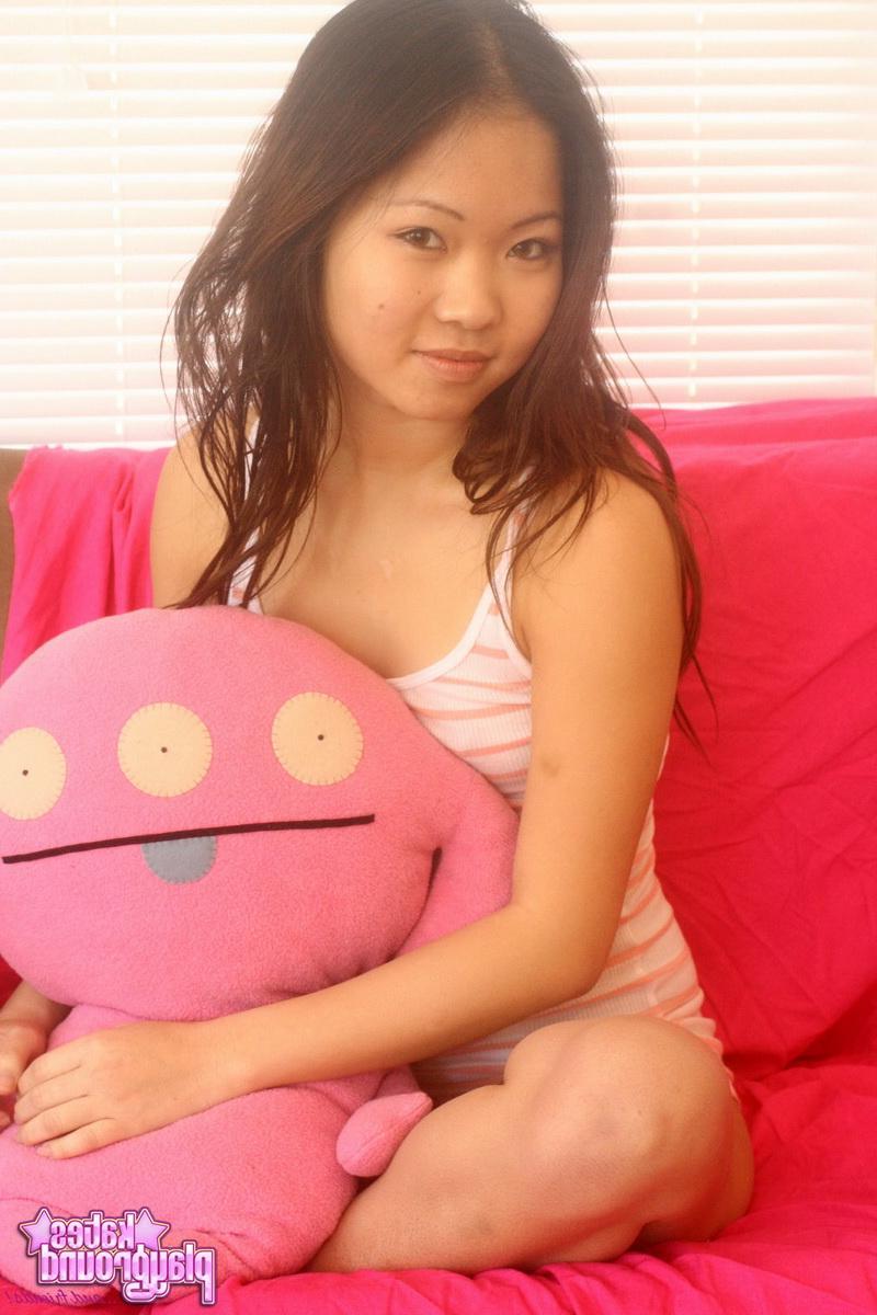 12P Asian cutie Grace teases with her tight little ass in a tiny red and pink thong