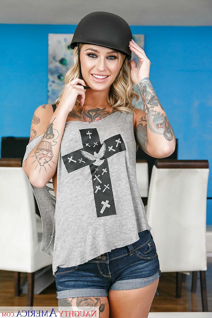 16P Tattooed blonde Kleio Valentien removing riding cap and clothes to pose naked