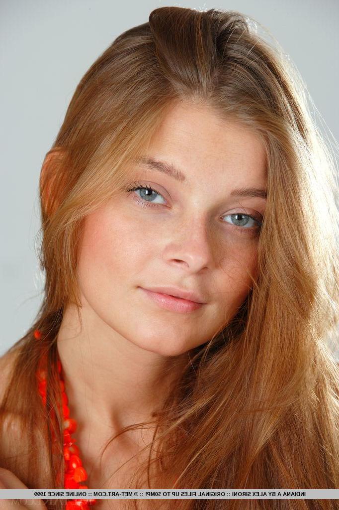 18P Redhead beauty Indiana A lays back and exposes her pussy