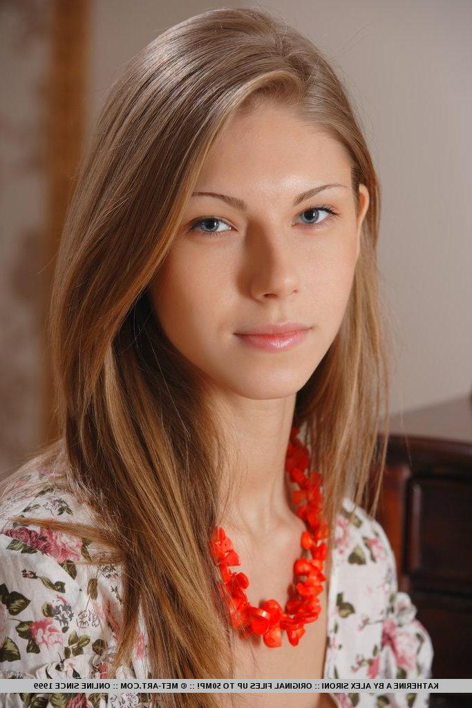 18P Pictures of redhead teen Katherine A stripping naked for you on the chair