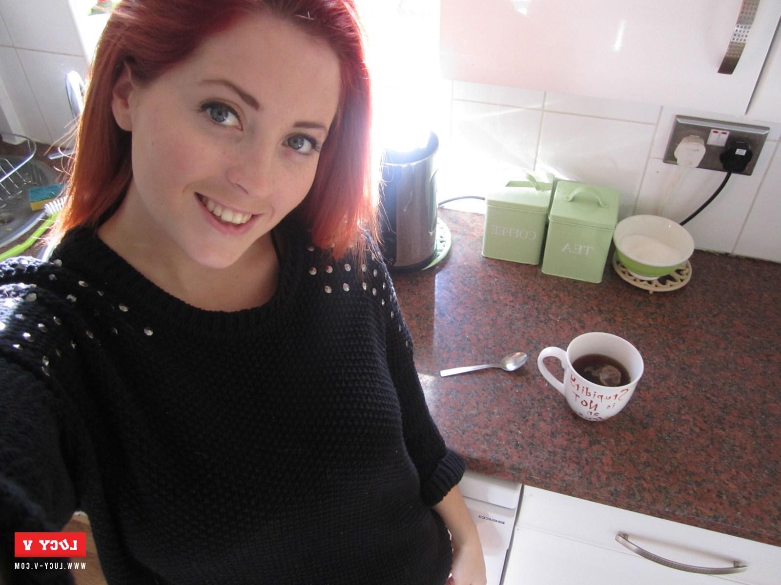 12P Sexy redhead model Lucy V strips in the kitchen just for you