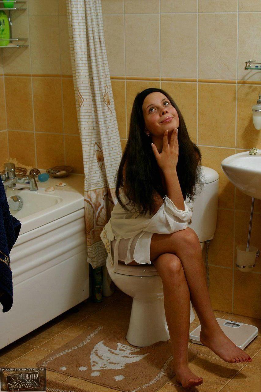 15P Pictures of teen chick Naughty Christine getting wet in the shower