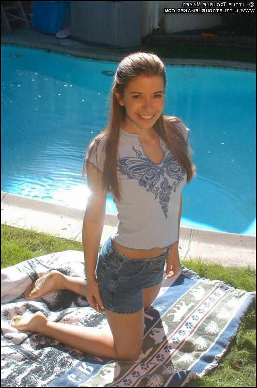 20P Pictures of a redhead teen getting naked outside