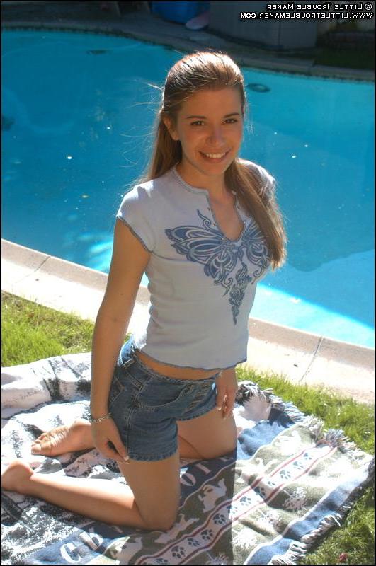 20P Pictures of a redhead teen getting naked outside
