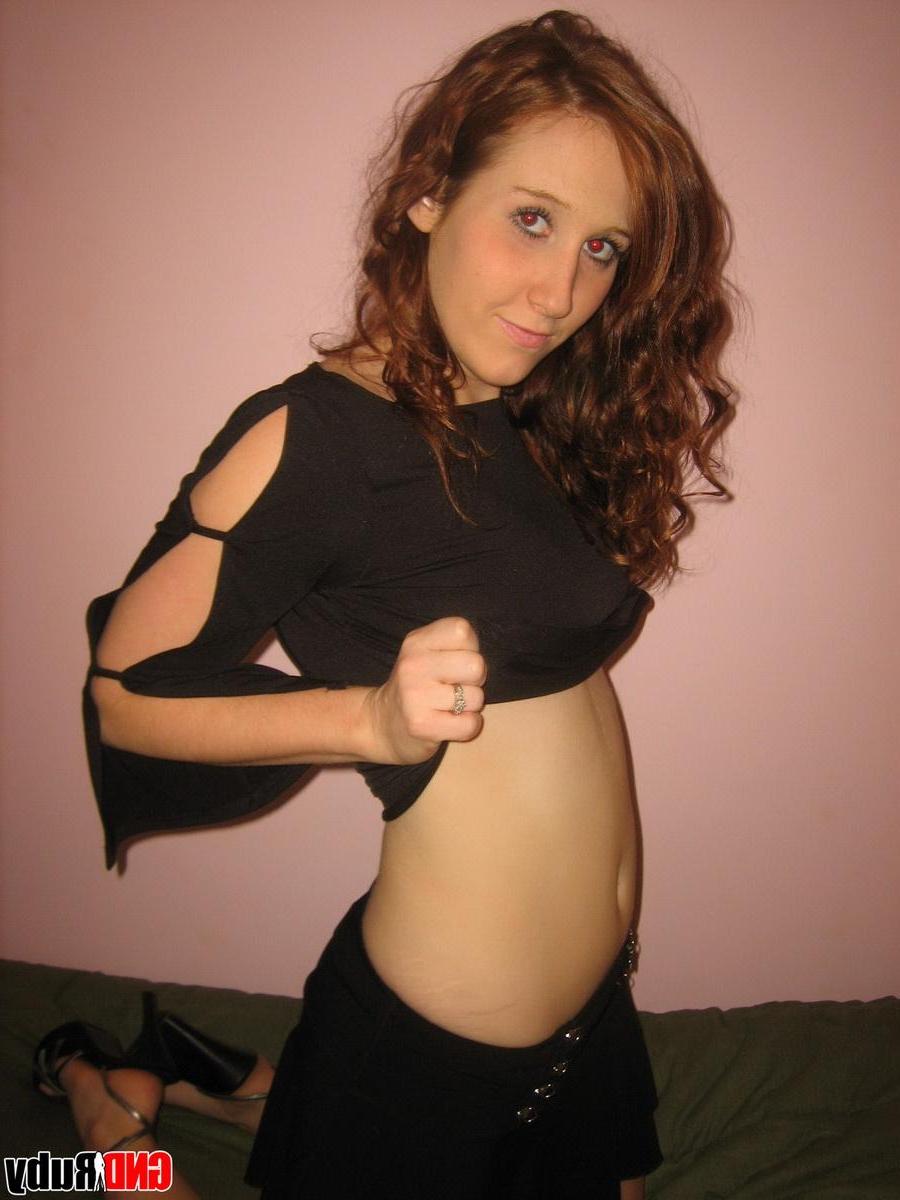 12P Super horny redhead teen Ruby rubs her wet pussy while looking at a porn mag