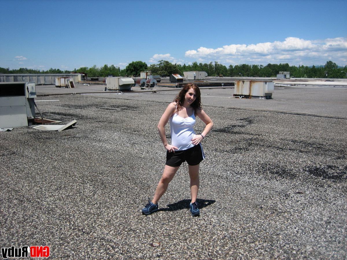 12P Horny redhead Ruby flashes her tits on the roof as she rubs her wet pussy