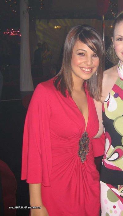16P Hot brunette shows her cleavage in a sexy red dress