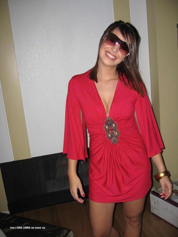 16P Hot brunette shows her cleavage in a sexy red dress