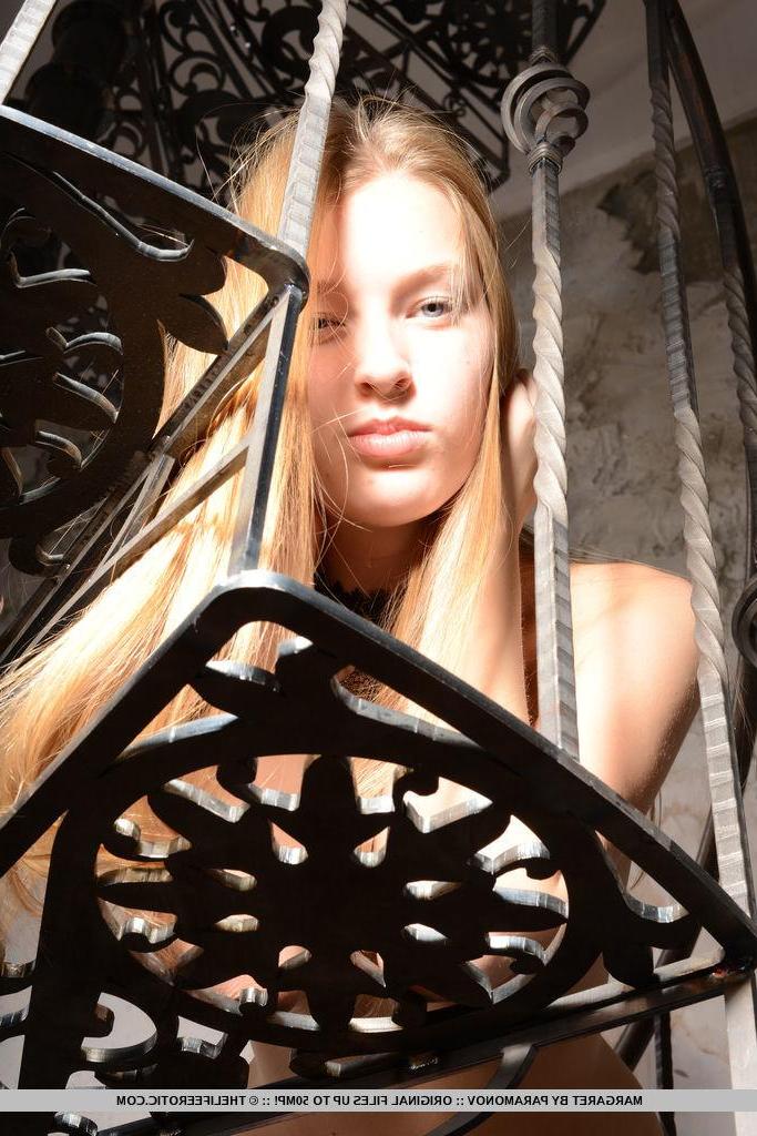 16P Gorgeous blonde model Margaret strips naked on an elegant staircase
