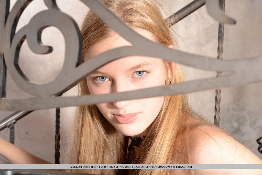 16P Gorgeous blonde model Margaret strips naked on an elegant staircase