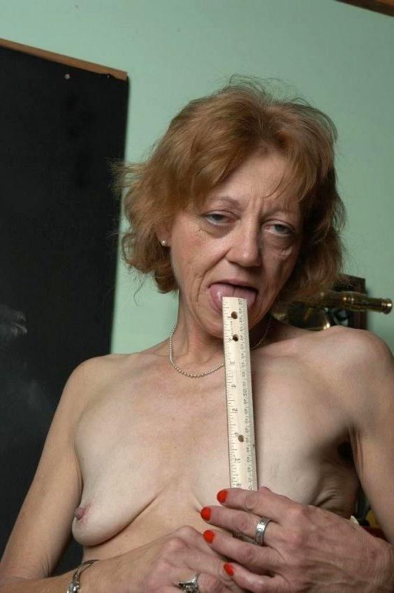 15P skinny old granny posing naked in classroom