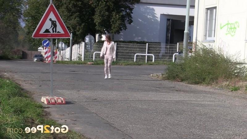 15P Brunette girl makes a pissy puddle on the road