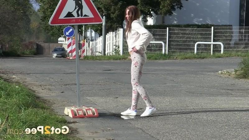15P Brunette girl makes a pissy puddle on the road