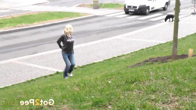 15P Pretty blonde pisses in public outside buildings