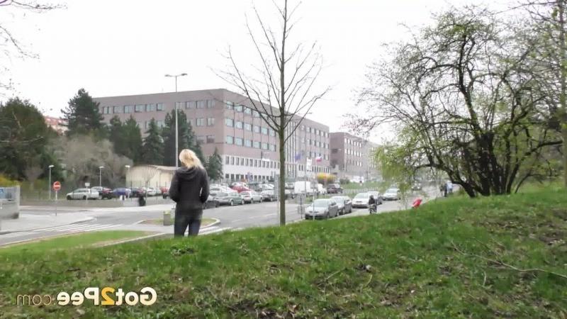 15P Pretty blonde pisses in public outside buildings