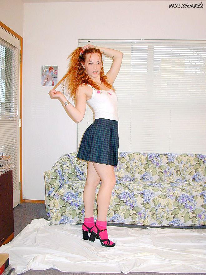 18P Pigtailed redhead in a skirt spreads her tight pussy and ass