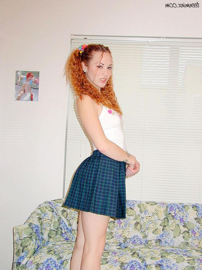 18P Pigtailed redhead in a skirt spreads her tight pussy and ass