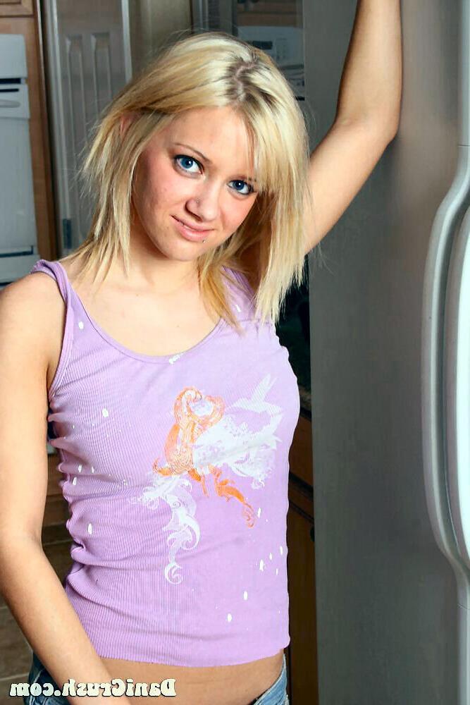 16P Dani Crush posing in her kitchen