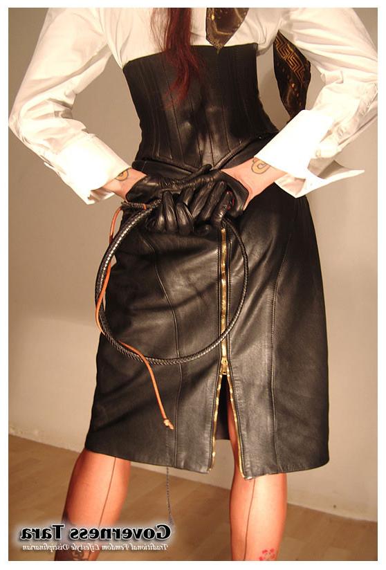 15P A strict brunette mistress posing in leather and high heels
