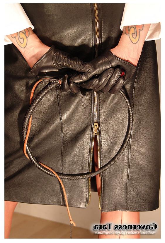 15P A strict brunette mistress posing in leather and high heels