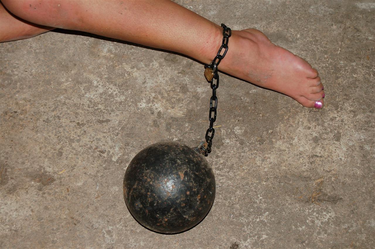 15P Cute blonde slave girl is chained up tightly inside her cell