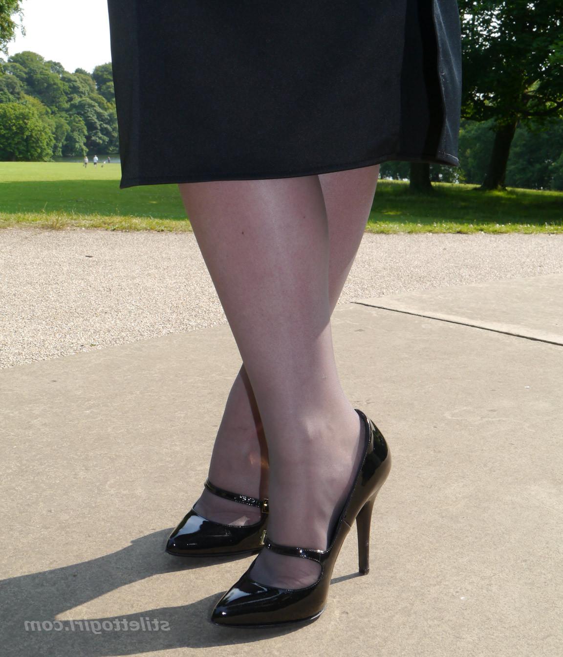 16P Hot office babe is outdoors posing in a pair of silky nylon stockings and stunni