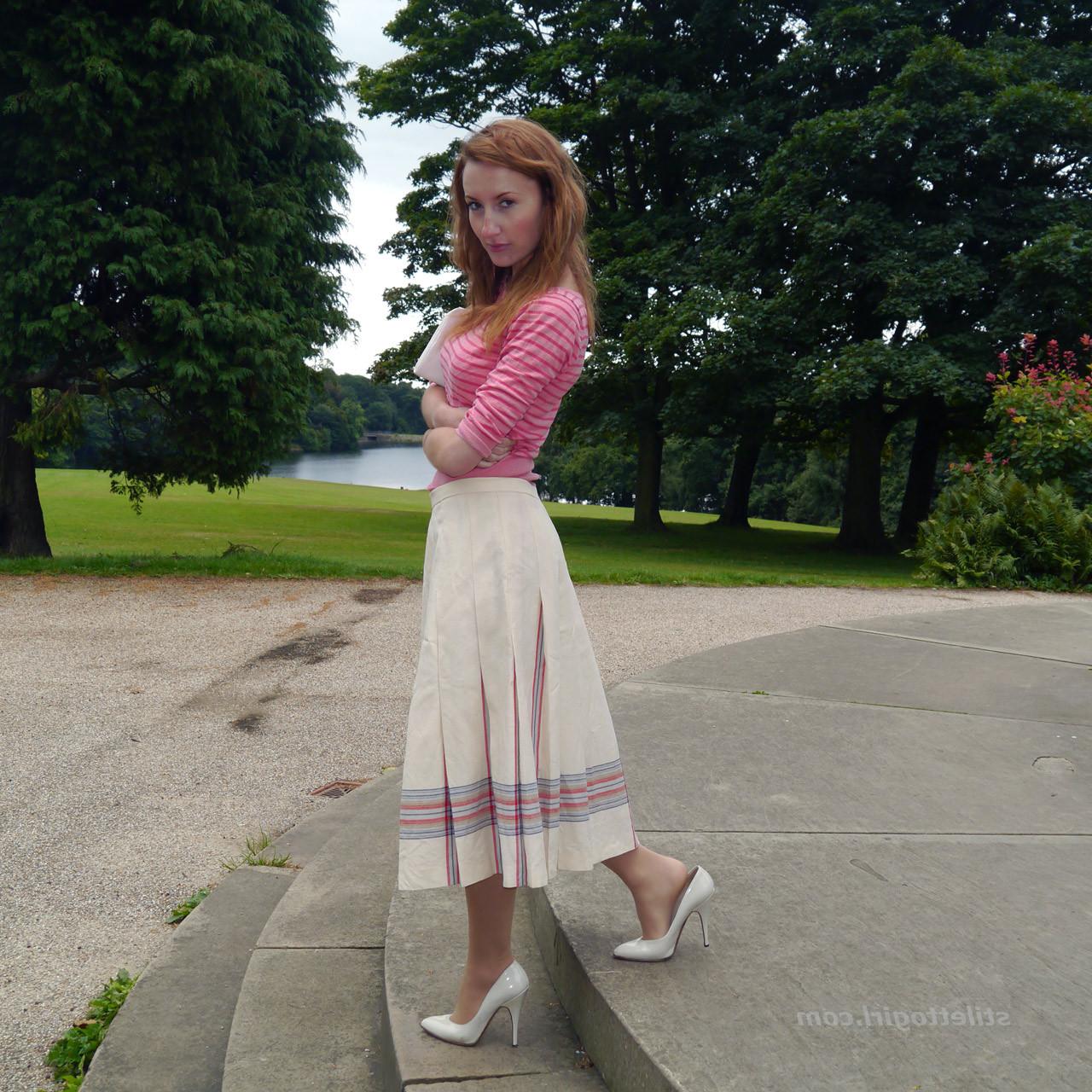 15P Cute redhead babe poses in a pair of lovely white high heeled stilettos for all 
