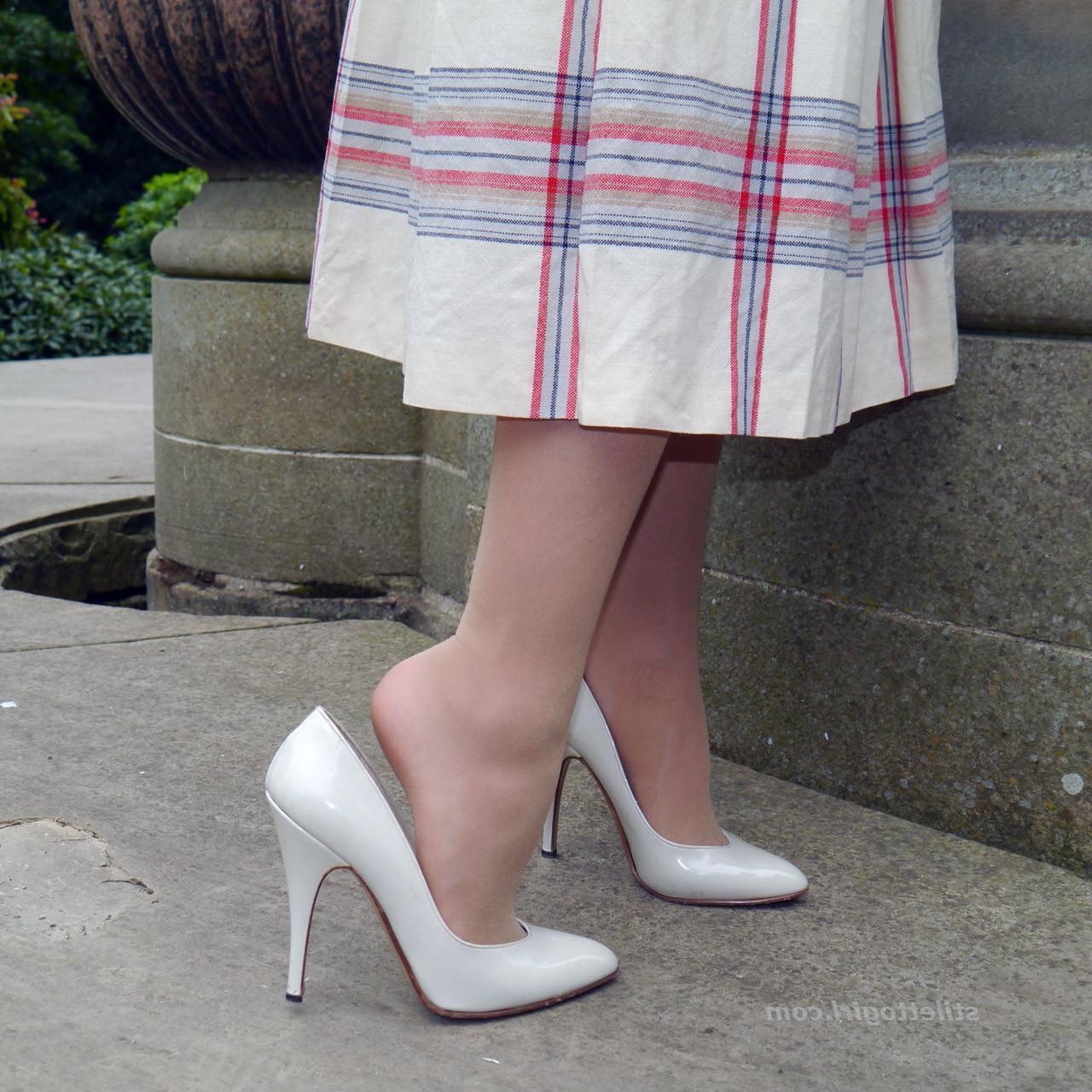 15P Cute redhead babe poses in a pair of lovely white high heeled stilettos for all 