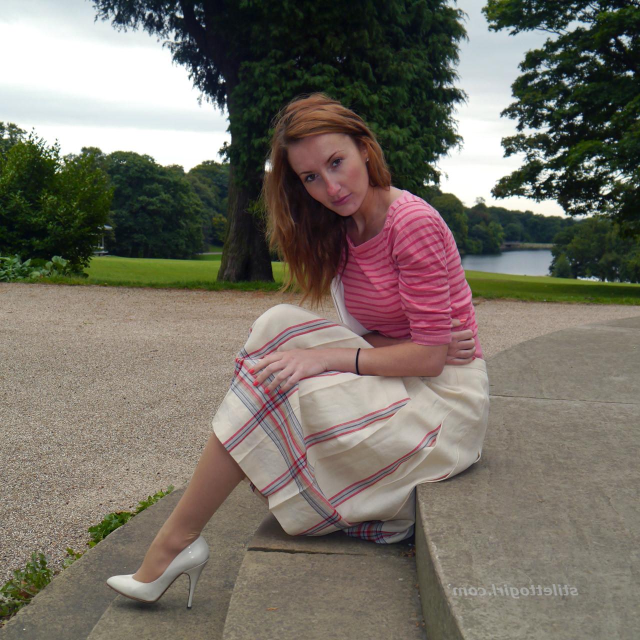 15P Cute redhead babe poses in a pair of lovely white high heeled stilettos for all 
