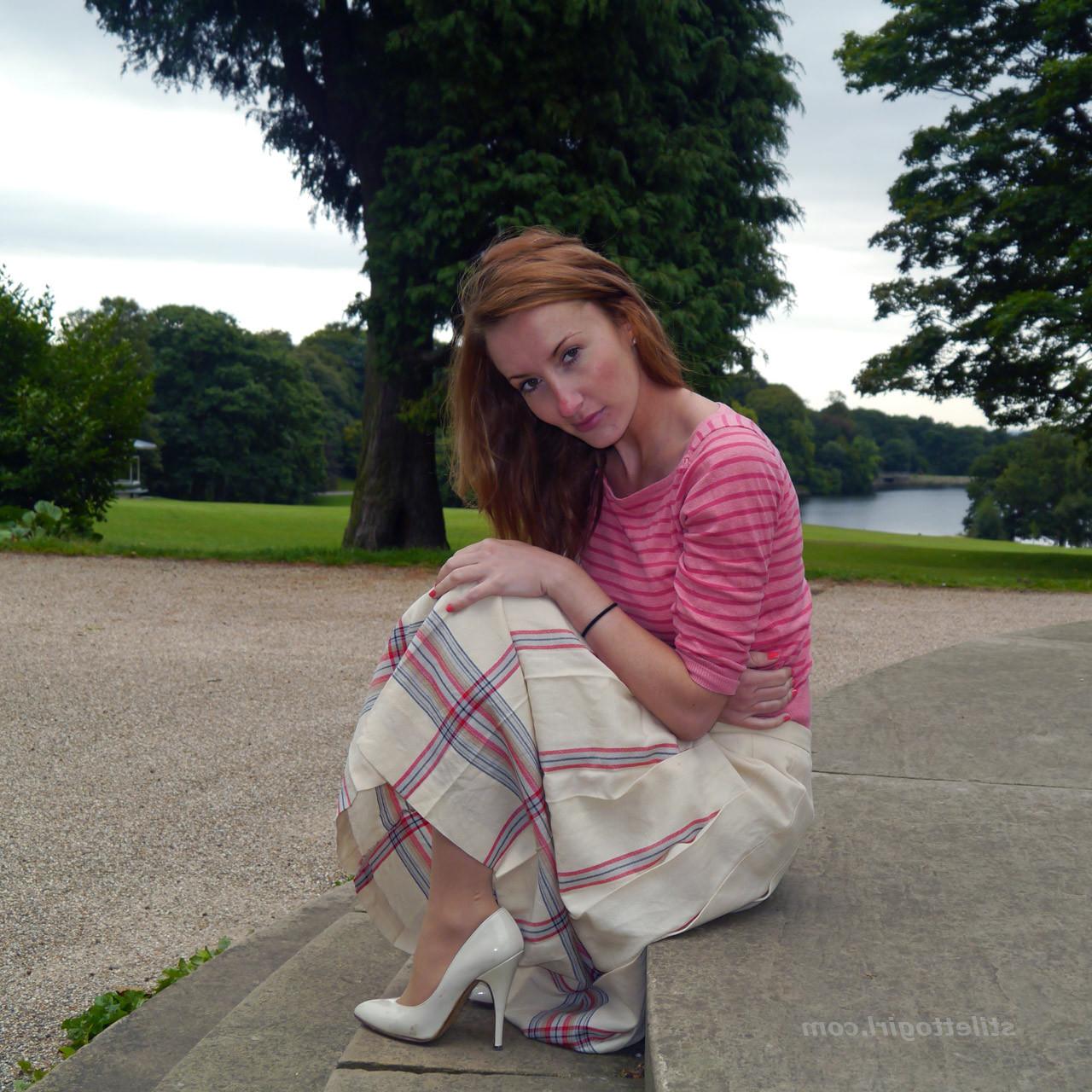 15P Cute redhead babe poses in a pair of lovely white high heeled stilettos for all 