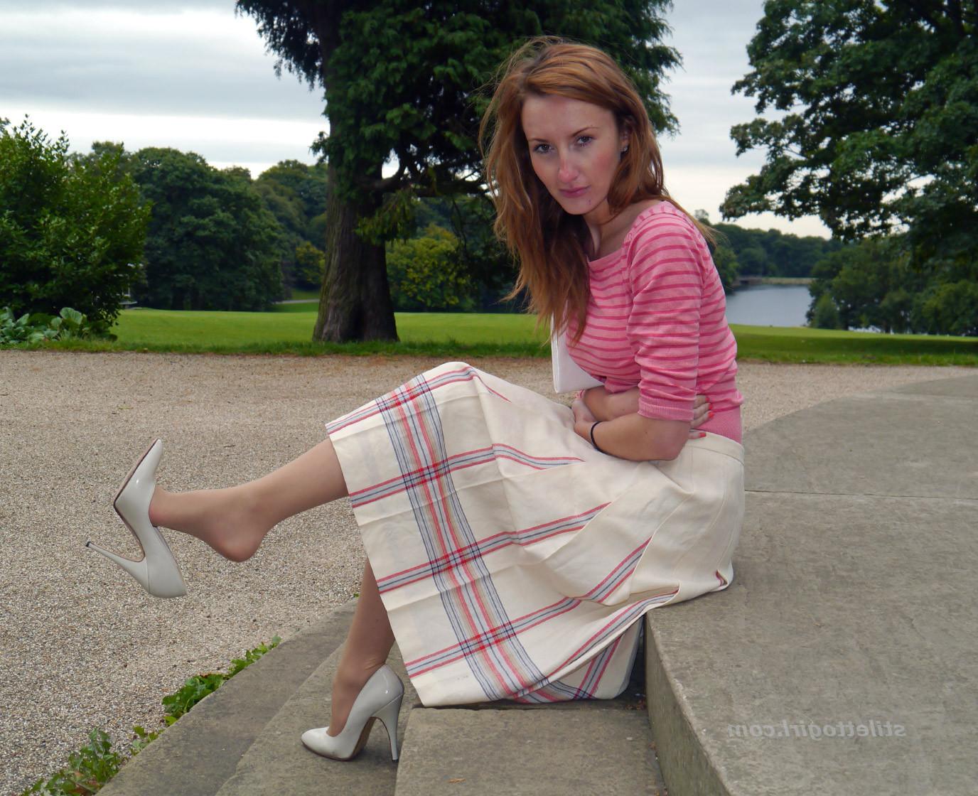 15P Cute redhead babe poses in a pair of lovely white high heeled stilettos for all 