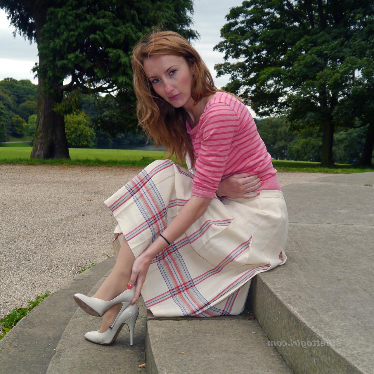 15P Cute redhead babe poses in a pair of lovely white high heeled stilettos for all 